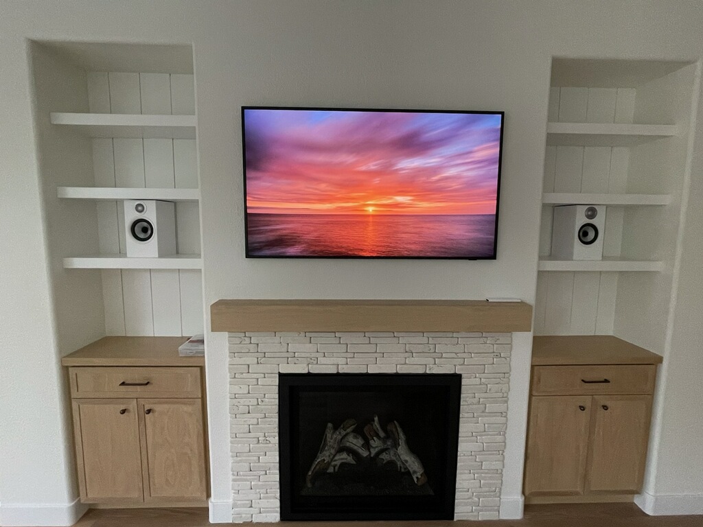 Custom living room built-ins with stacked-stone fireplace surround
