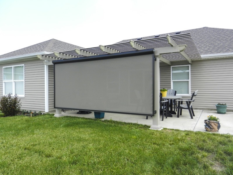 Sentry motorized solar screen lowered on the open west edge of a Kansas City porch as an alternative to a top awning