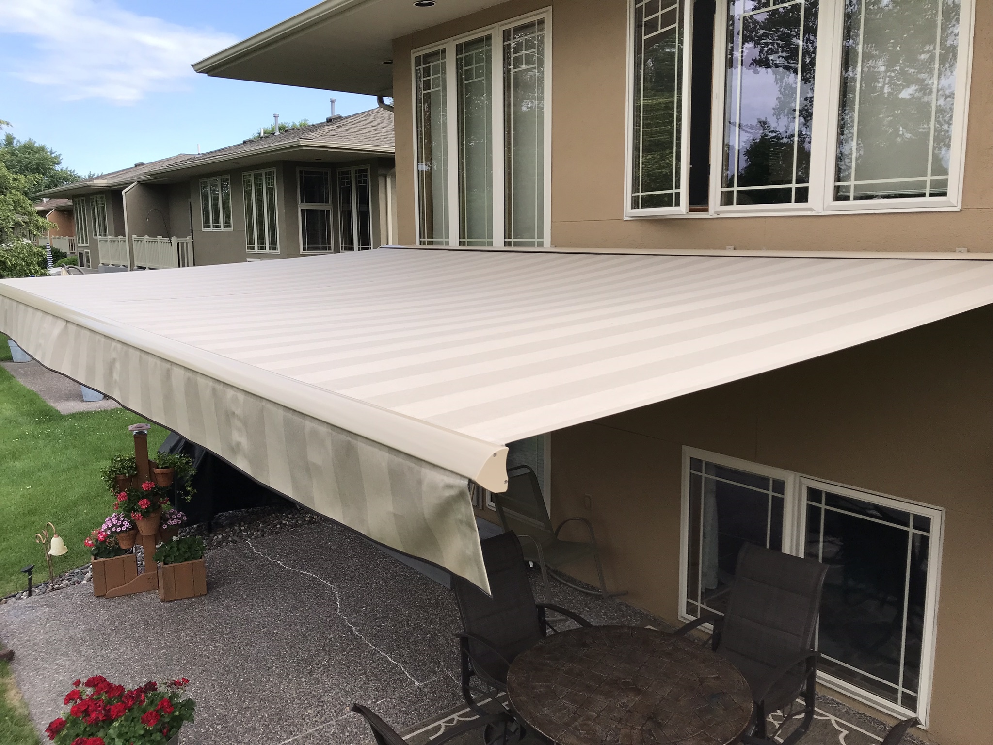 Sunesta retractable awning mounted to a Kansas City home wall with a concealed electric tubular motor