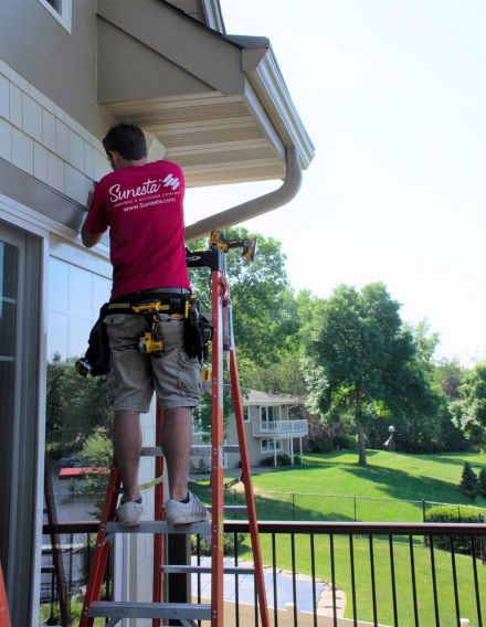 Retractable porch awning extended over the open edge of a Kansas City covered porch with no front posts