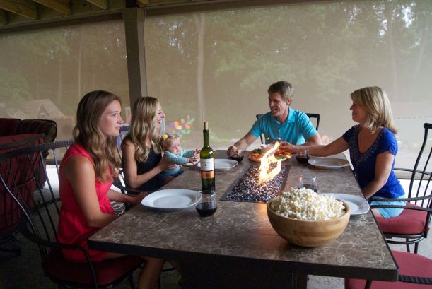 Family enjoying a deck enclosed with Sunesta retractable screens